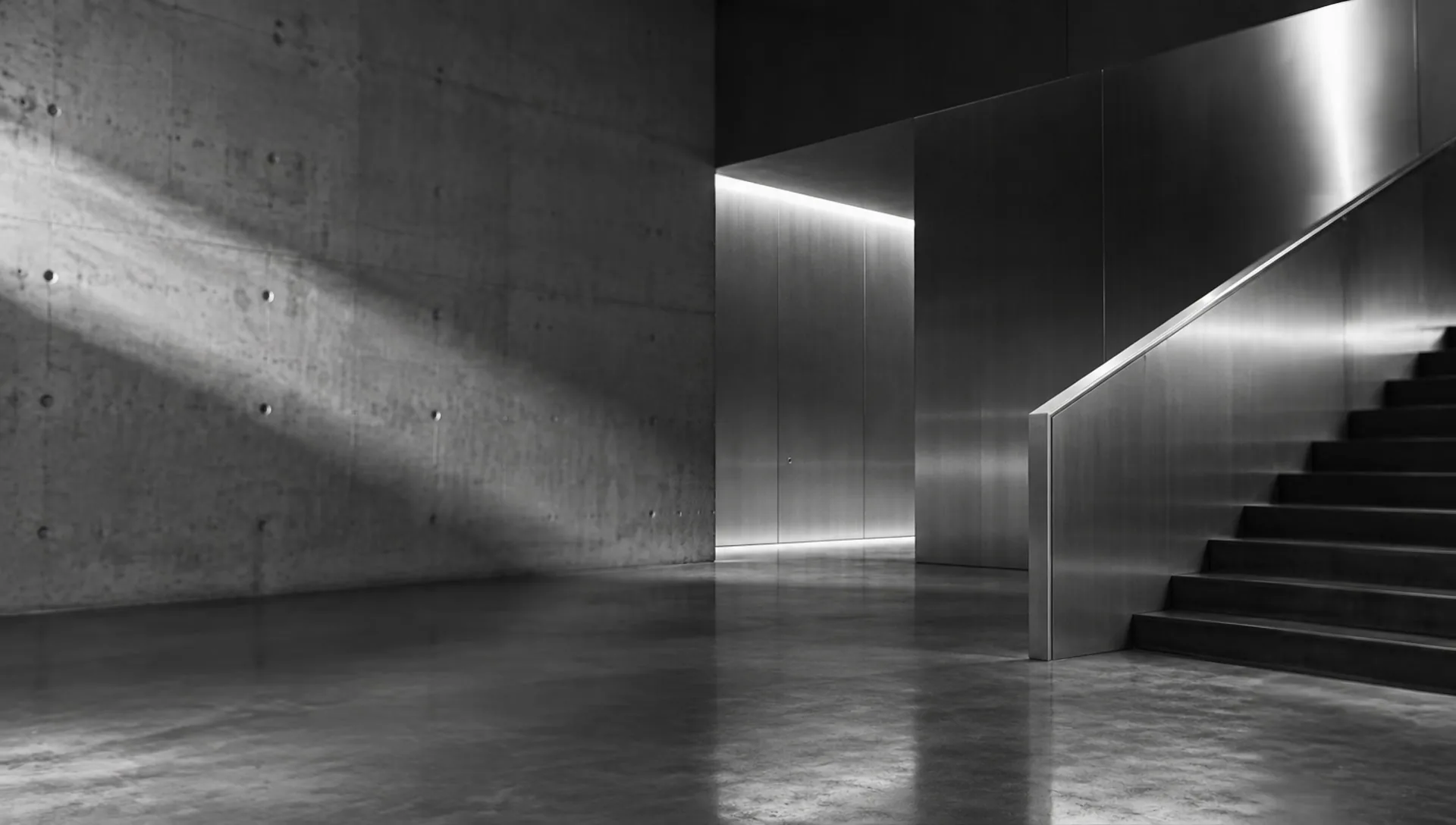 An empty concrete and steel architectural interior with dramatic light